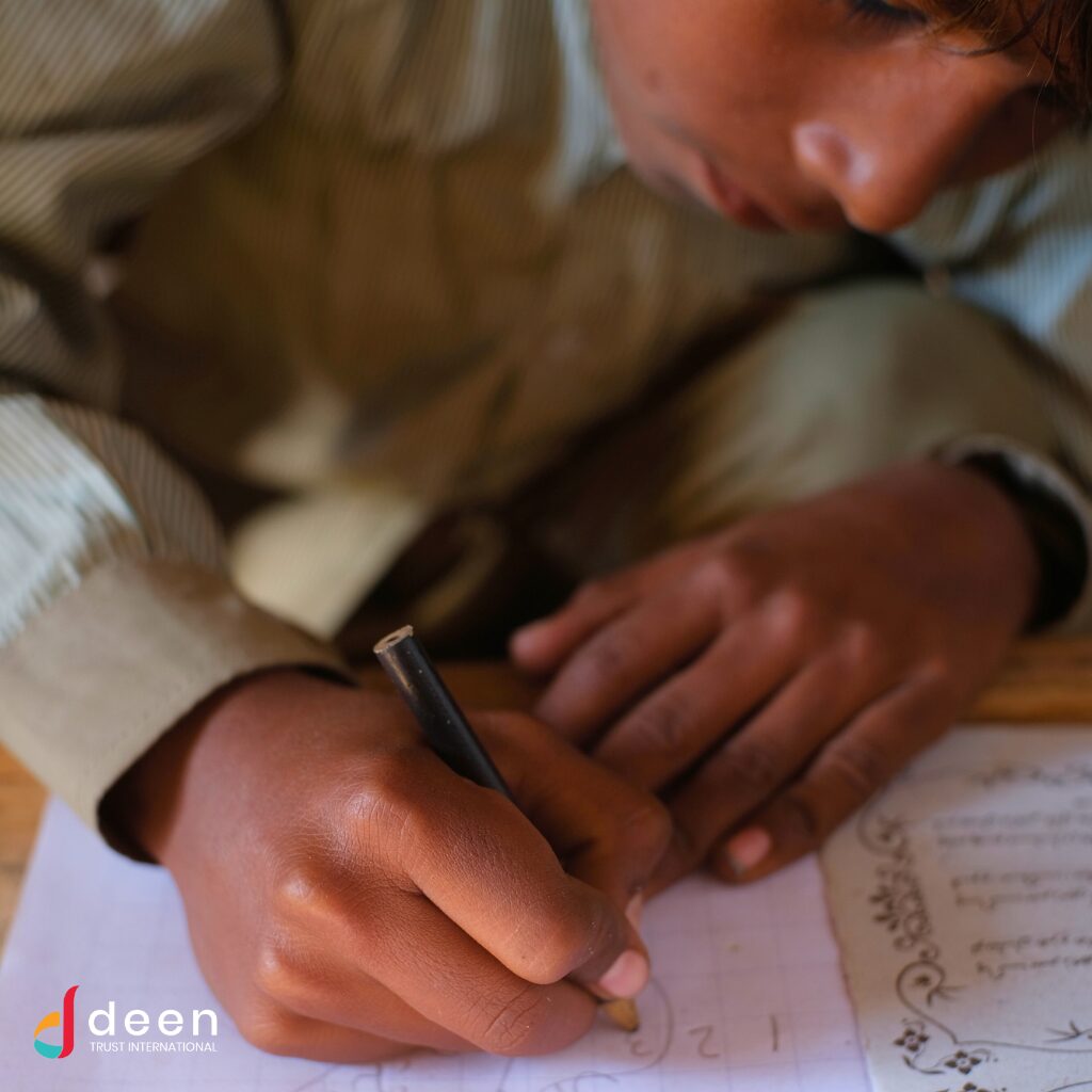 School boy studying at Deen Trust International School for the Underprivileged in temporary classroom